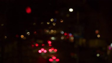 Abstract background of blurred car headlights at night with soft bokeh lights 
