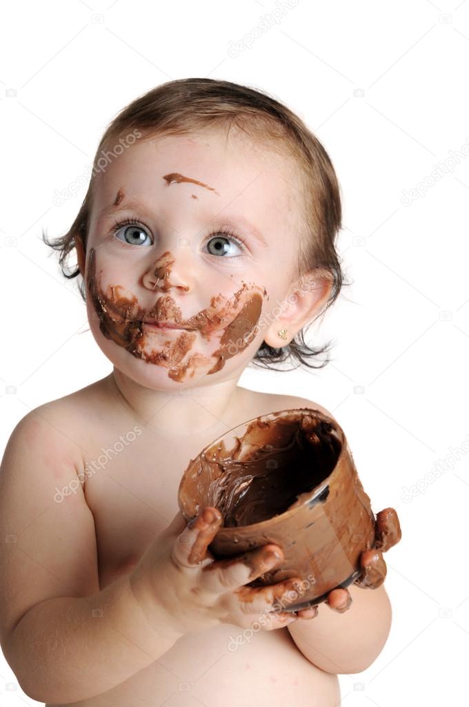 Baby enjoying the moment, eating chocolate