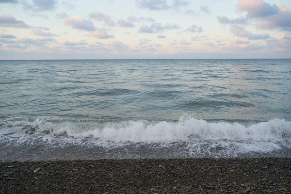 平静的海面上的日出向空中投射出橙色的光芒 夕阳西下的太阳穿过云朵 进入如画的平静的海景 — 图库照片