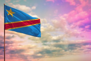 Fluttering Democratic Republic of Congo flag mockup with the place for your text on colorful cloudy sky background.