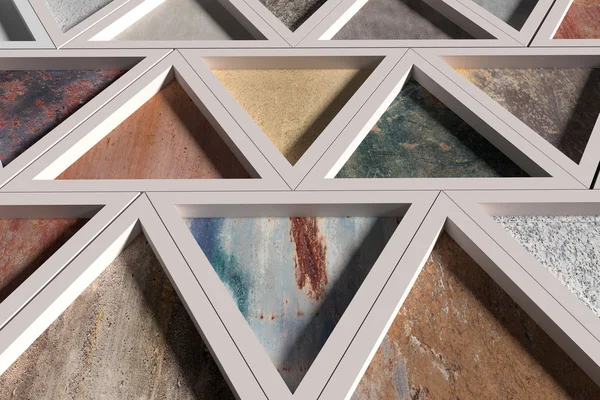 Wall with triangles of different materials in white frames — Stock Photo, Image