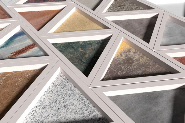 Wall with triangles of different materials in white frames — Stock Photo, Image