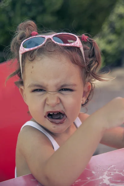 Girl making faces while looking at camera — Stock Photo, Image