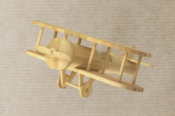 Wooden airplane on paper textured background — Stock Photo, Image