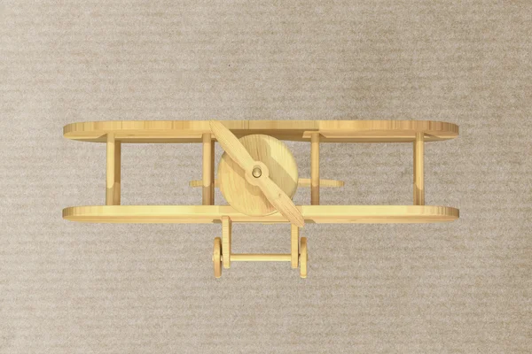 Avión de madera sobre fondo texturizado de papel —  Fotos de Stock