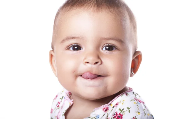 Portrait of lovely baby girl sticking tongue out — Stock Photo, Image