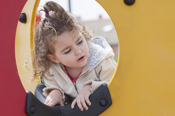 Close-up of little kid looking out of hole — Stock Photo, Image