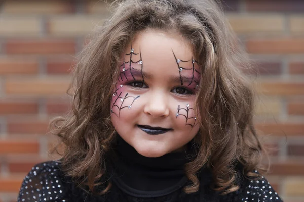 Lovely little girl looking at camera in Halloween — Stock Photo, Image