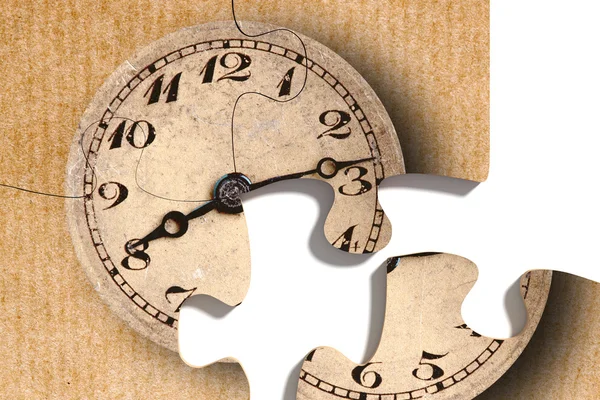 Old-fashioned clock print on puzzle pieces