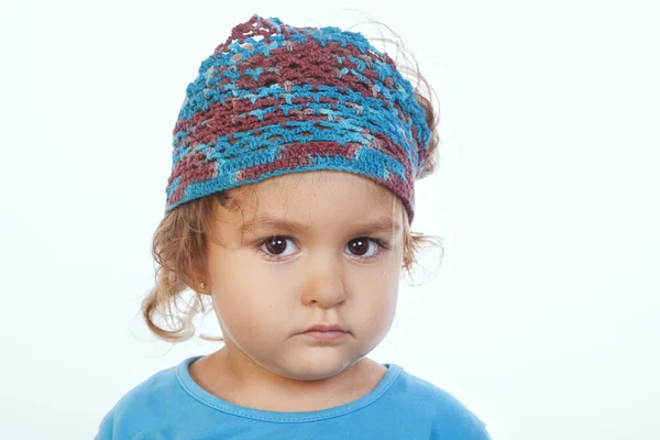 Adorable calm girl looking at camera and wearing blue handmade h — Stock Photo, Image