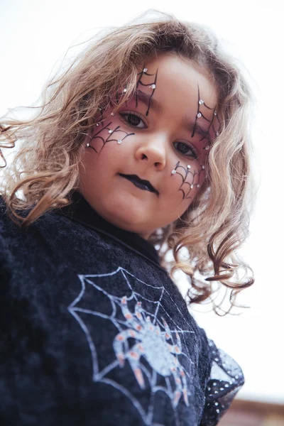 Lovely little girl looking at camera in Halloween — Stock Photo, Image