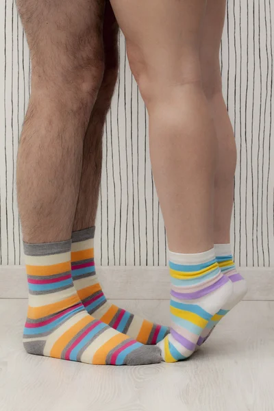 Feet of a beautiful couple with striped socks — Stock Photo, Image