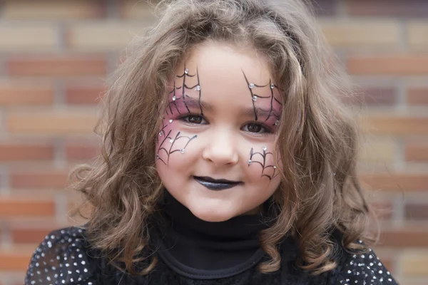 Little girl with spider web painted on face — Stock Photo, Image