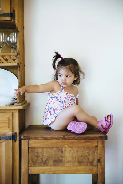 Lovely girl in dress pointing at something with finger — Stock Photo, Image