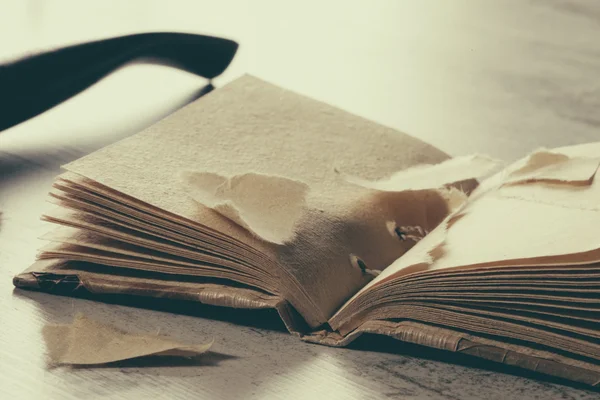 Torn book in hardcover on table