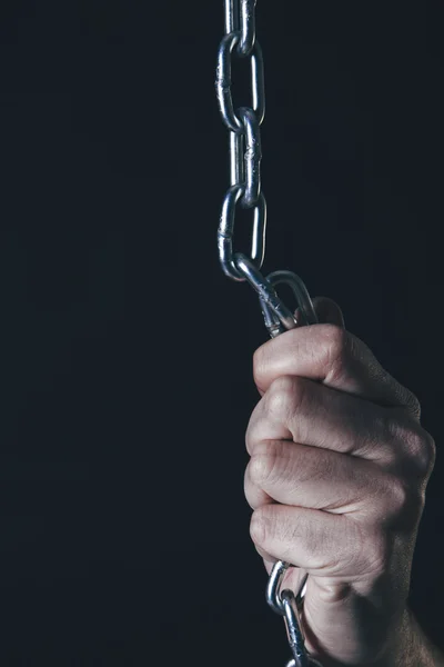 Man's hand holding silver chain — Stock Photo, Image