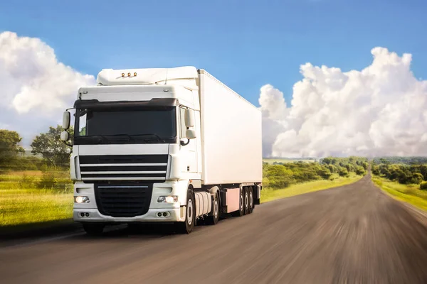 White truck moving on a road in summer