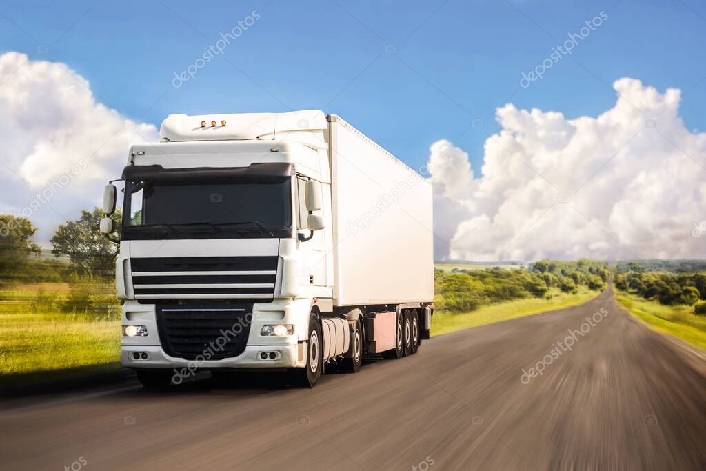 White truck moving on a road in summer