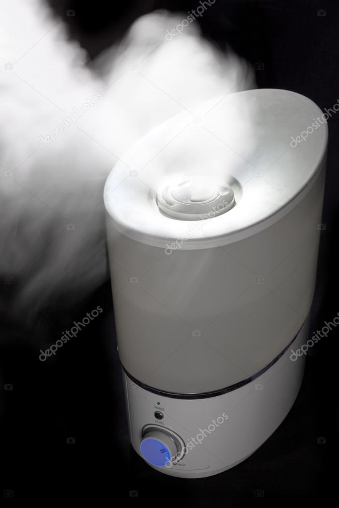 Humidifier spreading steam in  darkness
