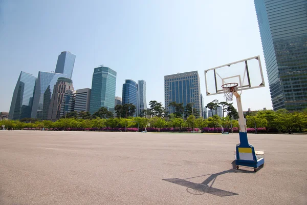 Streetball court in park area near office buildings in Seoul