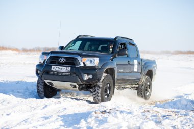 KHABAROVSK, RUSSIA - JANUARY 31, 2015: Toyota Tacoma during off clipart