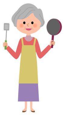 Yemek pişiren yaşlı bir kadın. Yemek pişiren yaşlı bir kadının resmi..