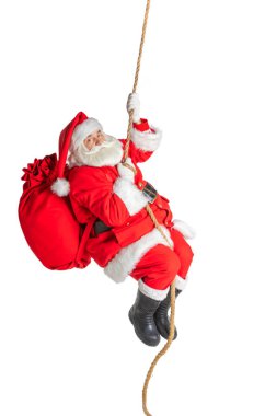 Noel Baba tırmanır, bir ipe sarkar, beyaz bir zemine..