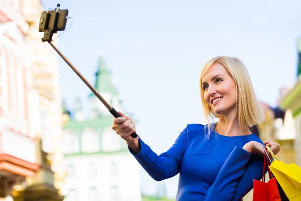 Giovani donne shopping all'aperto prendendo un selfie o autoritratto con il loro telefono cellulare — Foto Stock