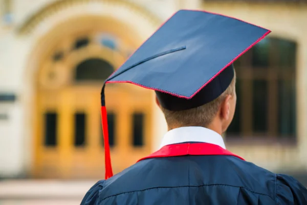 Graduate student hands holding diploma from the back — Stock Photo, Image