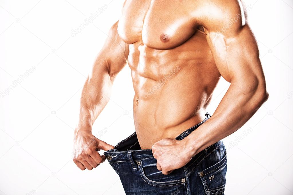 Strong Athletic Man showing muscular body and sixpack abs over white background.Muscular bodybuilder guy doing exercises with dumbbells over white background.Muscular man on white background