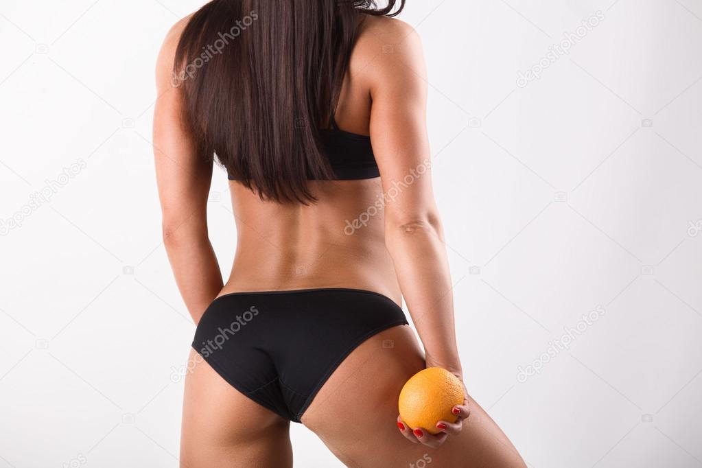 sporting beautiful girl with an orange rear view isolated on white background