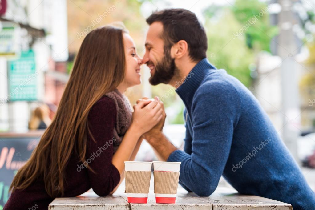 Man and woman drinking tea or coffee. Picnic. Drink warm in cool weather. Happy couple with coffee cups in autumn park. Love story concept.