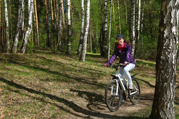 Велосипедні перегони - жінка на велосипеді в лісі — стокове фото