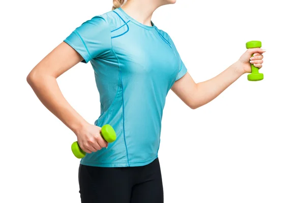 Athletic woman works out with green dumbbells — Stock Photo, Image