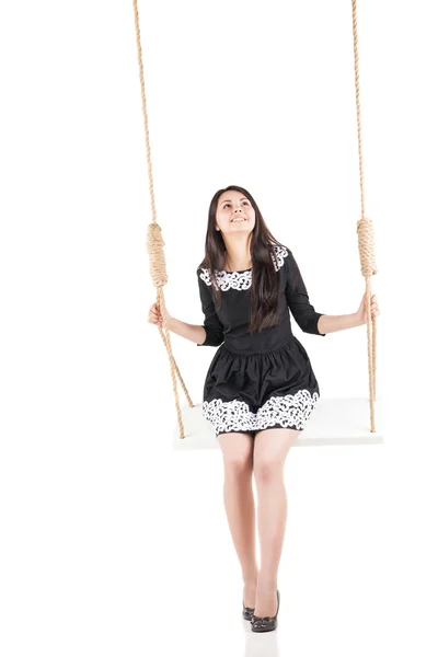 Beautiful girl swinging on swing over white — Stock Photo, Image