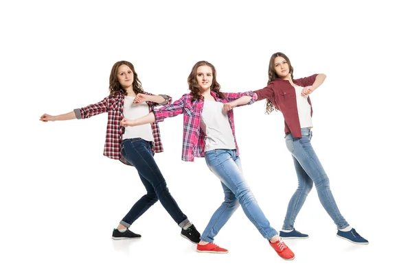 Three young women dancing over white background — Stock Photo, Image