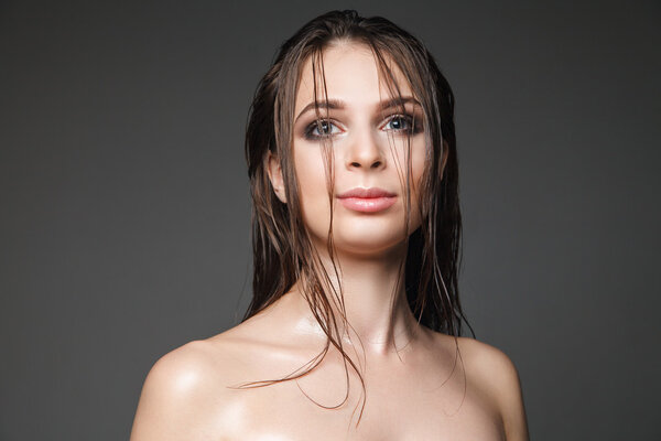 Headshot of wet-haired model with make-up