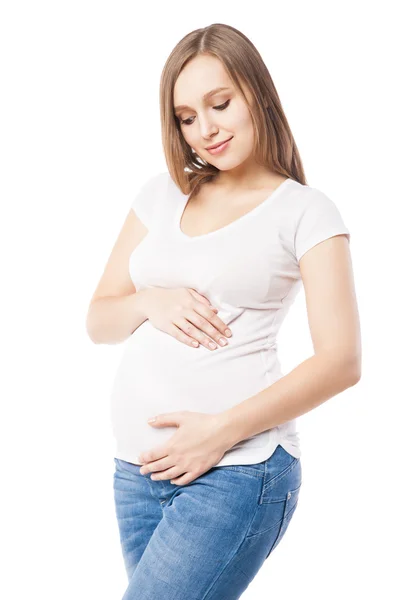Portrait of beautiful pregnant woman embracing belly Royalty Free Stock Images