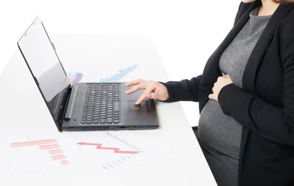 Businesswoman waiting for baby while working on laptop — Stock Photo, Image