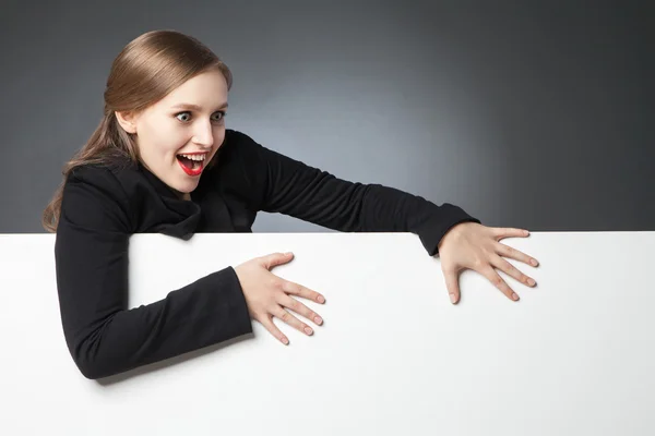 Surprised woman with open mouth loooking down — Stock Photo, Image