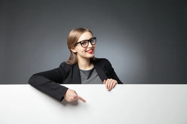 Smiling woman pointing at blank space — Stock Photo, Image