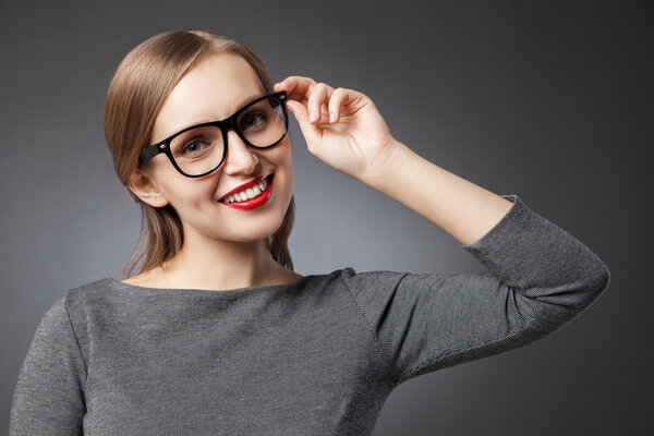 beautiful smiling woman in glasses looking at camera