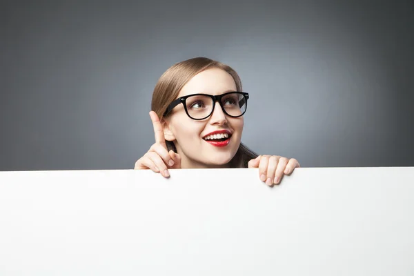 Woman with finger up looking at camera Royalty Free Stock Photos