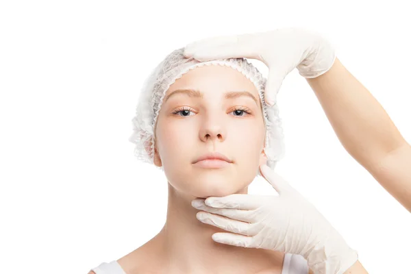 Hands in gloves holding girls face looking at camera — Stock Photo, Image