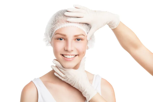 Hands in gloves holding girls face smiling at camera — Stock Photo, Image