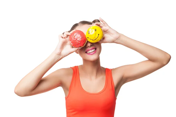 Young smiling woman covering eyes with donuts — Stock Photo, Image