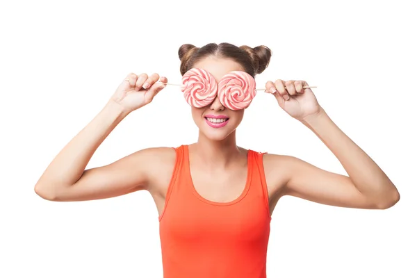 Portrait of woman with buns holding lollipops on eyes — Stock Photo, Image