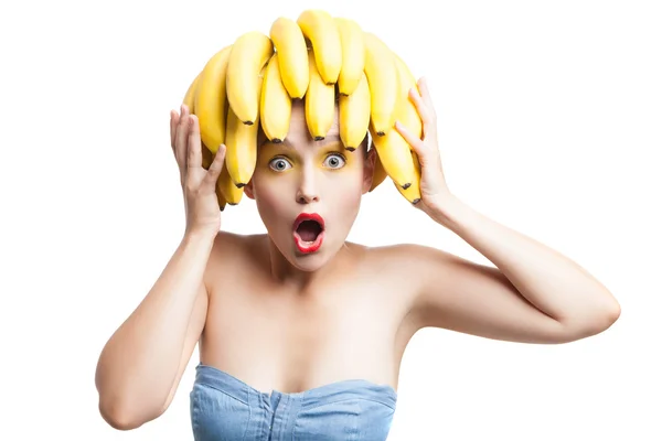 Portrait of amazed model with bunch bananas on head — Stock Photo, Image