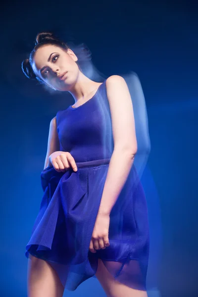 Attractive young woman in blue dress with hairstyle and make-up — Stock Photo, Image