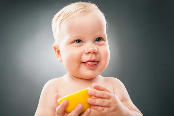 Ritratto di grazioso bambino con limone — Foto Stock